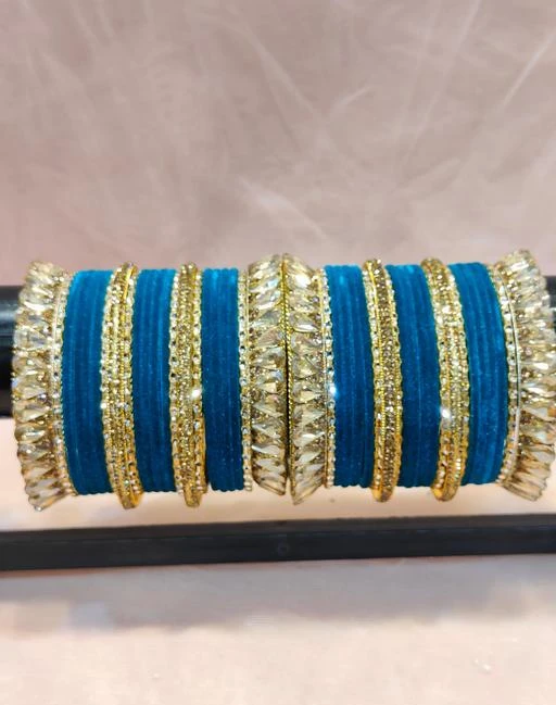Checkout this latest Bracelet & Bangles
Product Name: *Women’s Beautiful And Stylish Traditional Design Chooda With Bright Beautiful Teal  Color*
Base Metal: Brass
Plating: Gold Plated
Stone Type: Kundan
Sizing: Non-Adjustable
Type: Chooda
Net Quantity (N): More Than 10
Sizes:2.4, 2.6, 2.8
Paatla presents bridal chooda set is artistically handcrafted by skilled artisans with smooth finishing that reflects ethnicity and grace.Standard grade Acrylic, brass, stones and kundan are used to made royal chudas set; it not only gives the traditional vibes but also ensures durability.Gift this beautiful Rajasthani Chudas set to women on her special or auspicious occasion. It will certainly adore the hands with its bright colors.Women love jewellery; specially Bangles adore a women. They wear it on different occasion. They have special importance on ring ceremony, wedding and festive time. They can also wear it on regular basics. Make your moment memorable with this range. This Bangle set features a unique one of a kind traditional embellish with Royal finish.
Country of Origin: India
Easy Returns Available In Case Of Any Issue


SKU: TILAK_CHOODA_T
Supplier Name: THAR BANGLES

Code: 995-113794865-008

Catalog Name: Princess Chic Bracelet & Bangles
CatalogID_33091516
M05-C11-SC1094